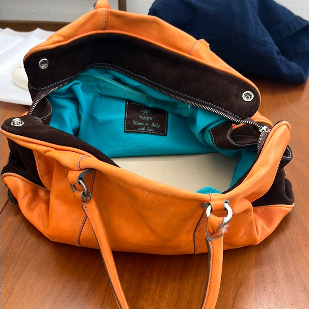 Vibrant Orange Shoulder Bag with Slouchy Style and Silver Hardware